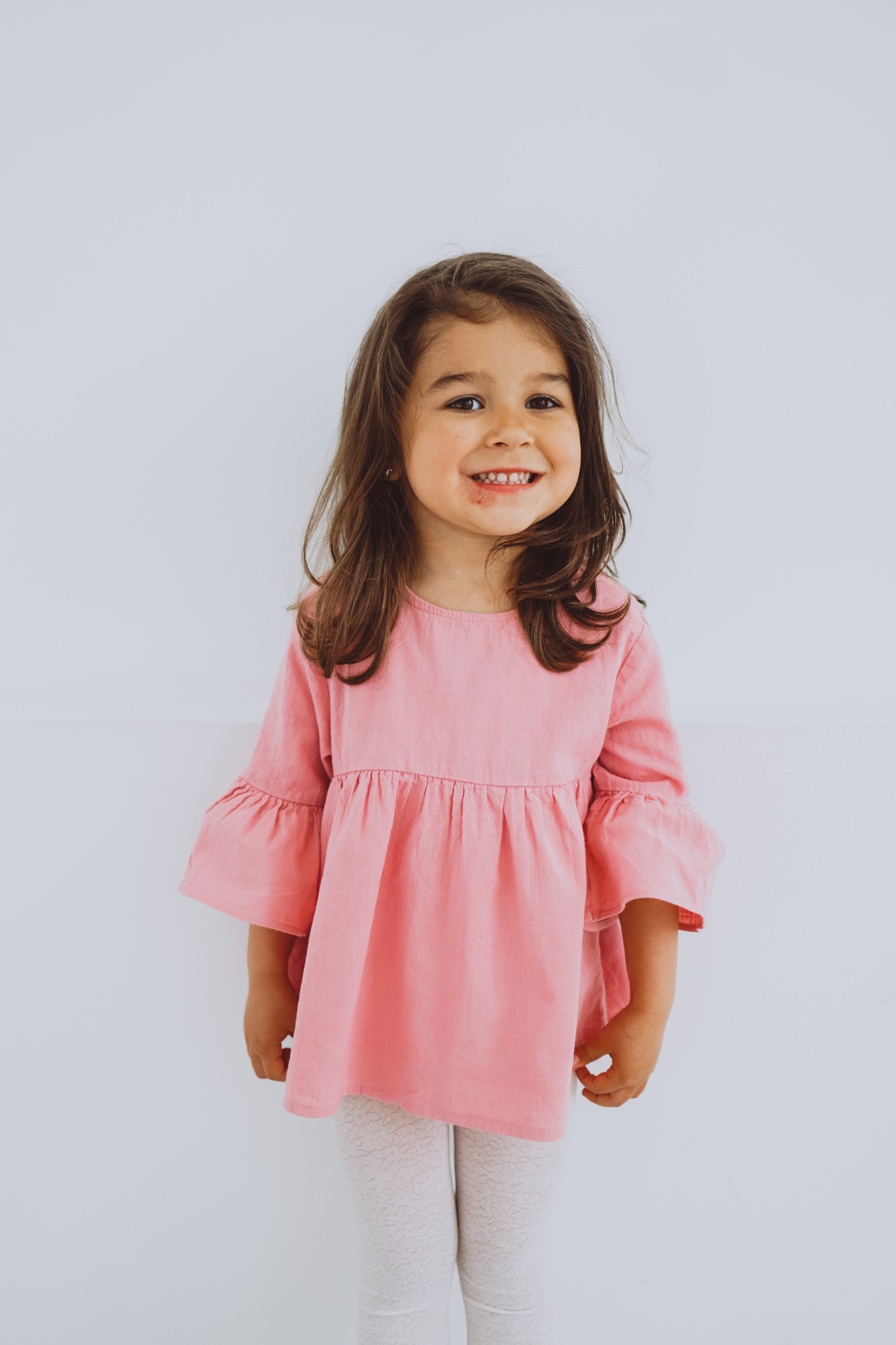 Portrait of a Smiling Little Girl in Pink Blouse
