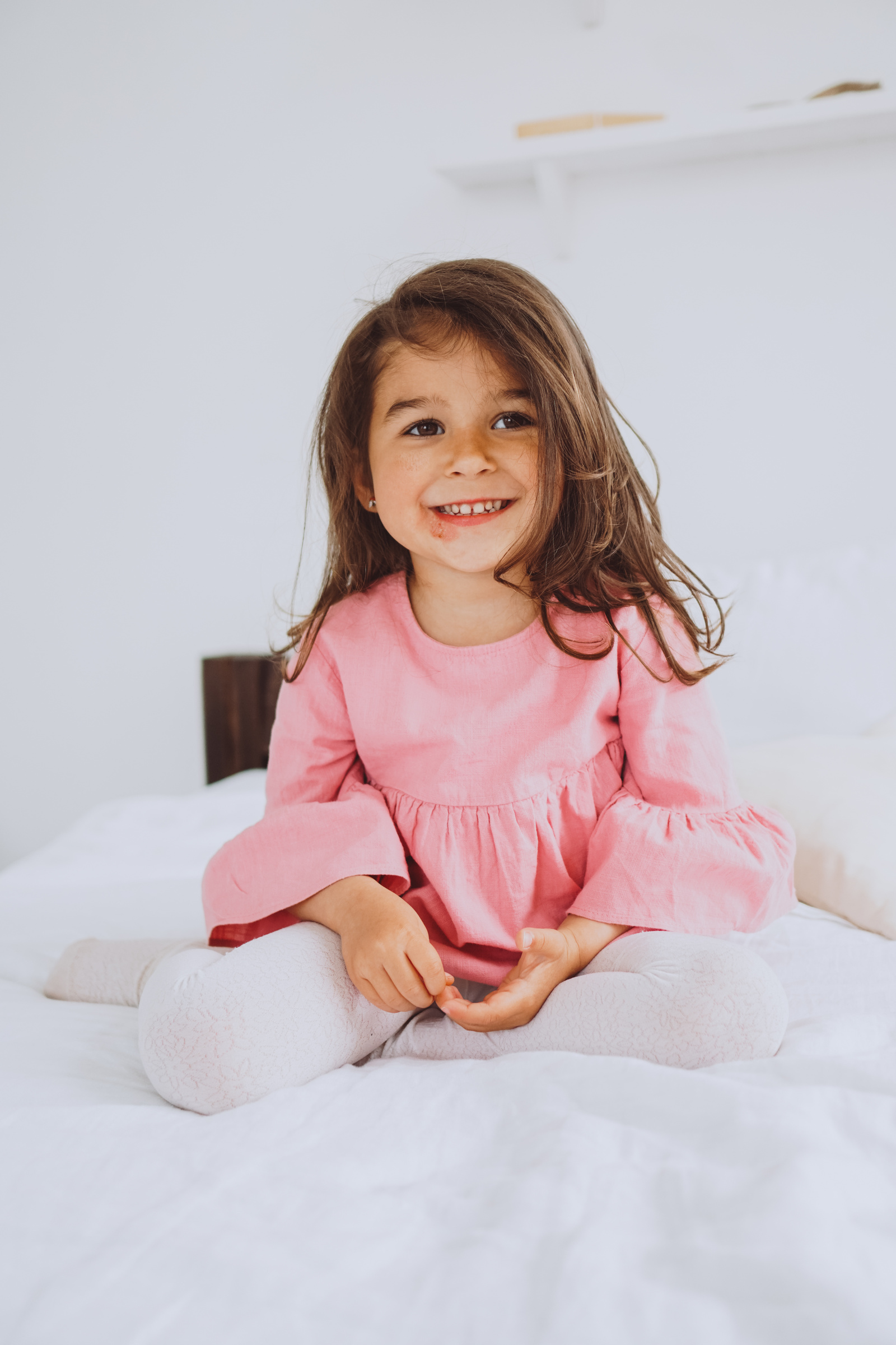 Little Girl Sitting in Bed